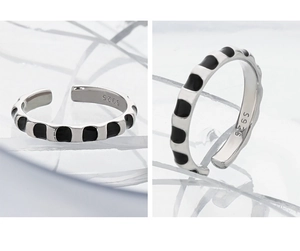 Macro detail of S925 sterling silver ring featuring black enamel patterns and S925 stamp