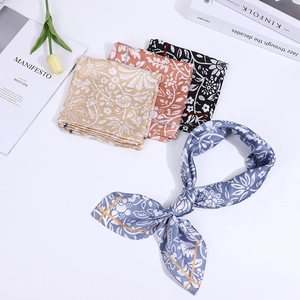 Flat lay of colorful floral silk neckerchiefs with tulips and lifestyle magazines