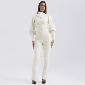 Detail view of cream white knitted lounge set featuring high collar buttons and lantern sleeves