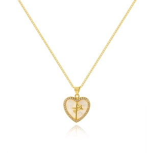 Macro view of gold heart necklace with mother of pearl inlay and crystal letter J