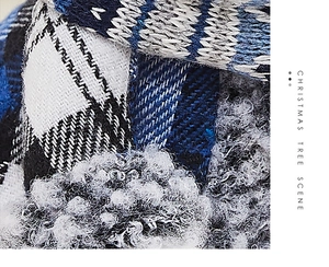 Close-up of blue plaid fabric and wool textures on a Christmas snowman doll detail