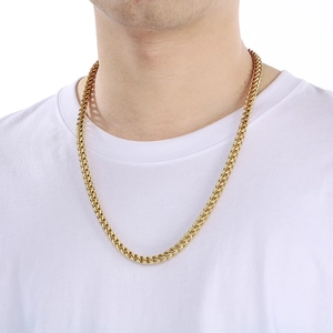 Close-up of gold-plated stainless steel keel chain necklace worn by a model