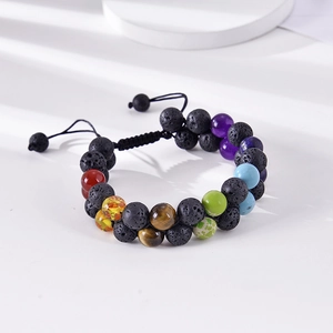 Detail of double-layer lava stone bracelet with colorful chakra beads and adjustable cord