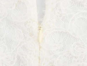 Detail shot of invisible zipper closure on high-quality white lace sleeveless maxi dress