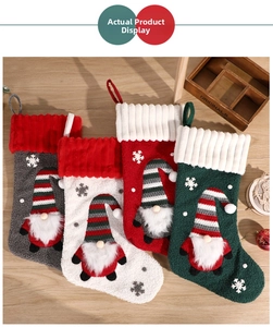 Detail of four Christmas stockings with embroidered gnomes on a rustic wooden table