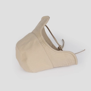Close-up detail of beige canvas sun hat with windproof drawstring and clean stitching