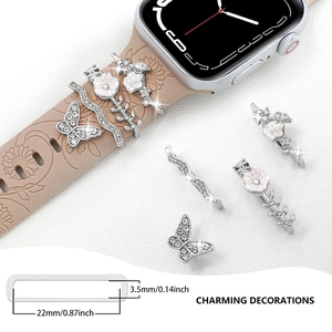 Detail of elegant butterfly and floral alloy charms with rhinestones for watch bands