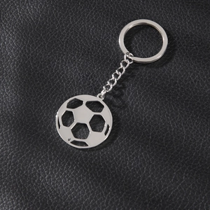 Silver stainless steel hollow soccer ball keychain charm on black leather background