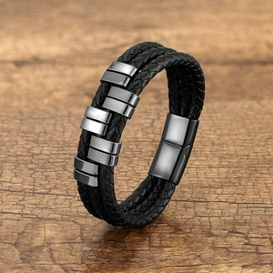 Detail of multi-layer black braided leather bracelet with silver magnetic metal clasp