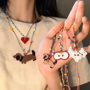 Detailed view of handmade wax cord necklaces featuring colorful glass charms and bead accents