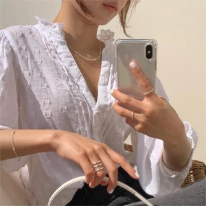 Elegant 925 sterling silver layered rings and O-chain necklace on a female model