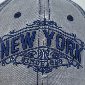 Faded grey-blue cotton baseball cap with New York 1985 embroidery in a front view