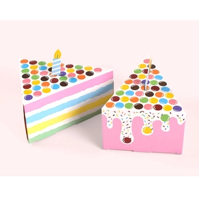 Detail of triangle cake gift boxes with rainbow stripes and candle topper for parties