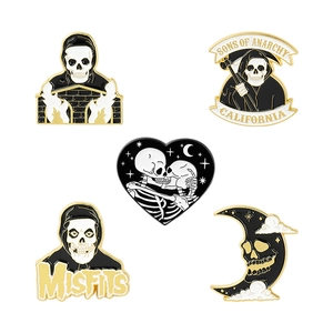 Five-piece dark style enamel pin set featuring skulls and reaper in black and gold alloy