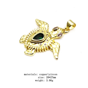 Detail of copper turtle pendant with green zircon inlay and size dimensions 28x27mm