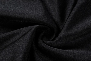 Macro shot of high-density black knit fabric showing soft texture for swimwear