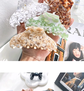Detail shot of acetate hair claws in floral, tortoiseshell and marble textures