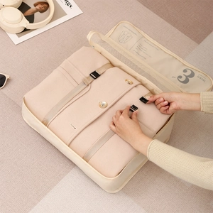 Beige travel clothes organizer bag with buckle straps for luggage packing efficiency
