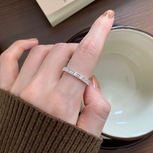 Close-up of a delicate 925 sterling silver ring with shimmering pavé set zircons
