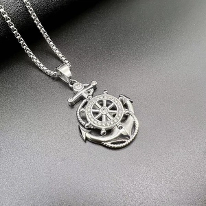 Detail of silver anchor and rudder pendant with cubic zirconia and box chain