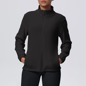 Detailed close-up of the fleece texture and zipper pocket on a black sports jacket