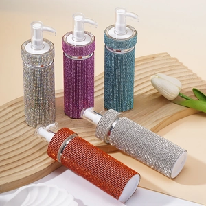 Detailed shot of luxury rhinestone-covered cosmetic pump bottles in multiple colors