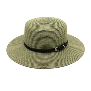 Close-up of matcha green straw hat with fine weave texture and black leather strap