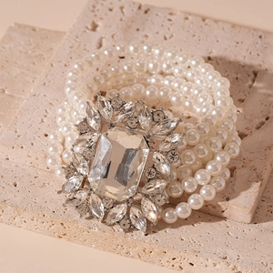 Macro shot of multi-layer pearl necklace with a large crystal buckle and rhinestone details