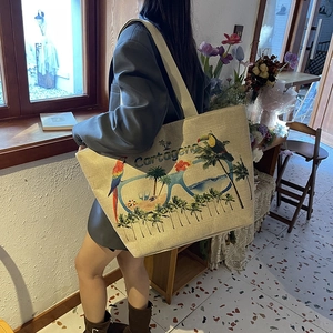 Linen tote bag with tropical parrot pattern and Cartagena print on a female model