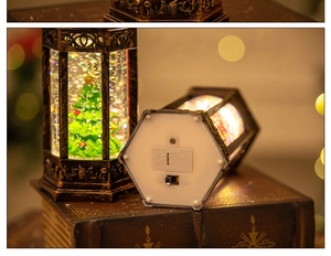 Close-up of vintage bronze Christmas lantern base showing battery slot and power switch