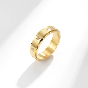 Gold stainless steel star spinner ring with brushed metal finish and tiny inset crystals