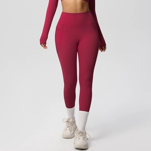 Detail view of high-waisted dark red yoga pants featuring functional side pockets