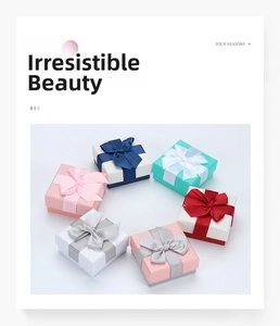 Colorful jewelry gift boxes with silk ribbon bows in pink blue and white colors