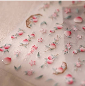 Detail of peach blossom nail art stickers with elegant pink fruit and leaf patterns
