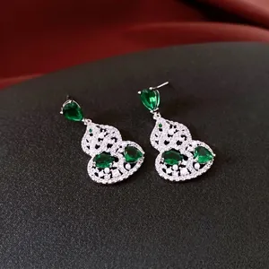 Silver wulu earrings with green pear-cut zircon and white pearls in minimalist style