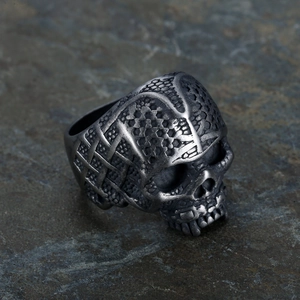 Gothic punk men's stainless steel skull ring with grid texture on stone background
