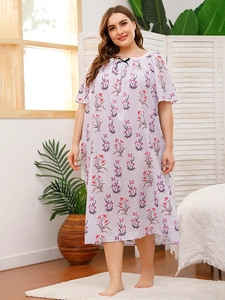 Detail of white lace collar with black bow on a floral print plus size nightdress