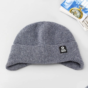 Detail of grey ribbed knit beanie showing the thick texture and star logo patch