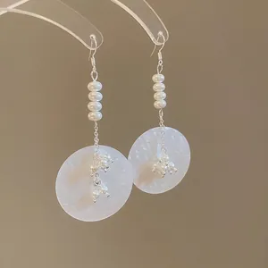 Elegant pearl drop earrings with large white round pendants and silver hooks for women