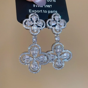 Detailed view of silver clover drop earrings with brilliant micro-paved cubic zirconia stones
