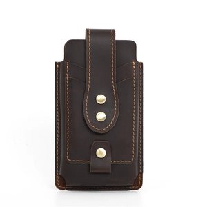 Close-up of deep brown leather phone pouch with metal rivets and vertical stitching details