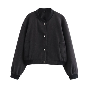 Detailed flat lay of a black tweed bomber jacket with metallic buttons and ribbed cuffs