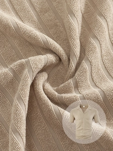 Detail of knit short-sleeve shirt showing premium vertical stripe texture and beige fabric
