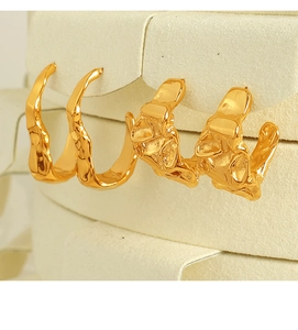 Close-up of 18K gold-plated irregular and lava texture hoop earrings on a display stand