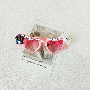 Pink heart-shaped kids sunglasses with Trick or Treat beads and UV400 protection