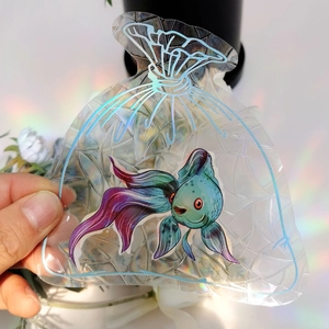 Detail of goldfish pattern suncatcher sticker with rainbow laser reflection effect