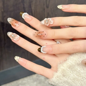 Brown and nude gradient press-on nails with 3D floral accents and polka dot patterns