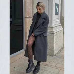 Women's long dark grey wool coat with double-breasted buttons in urban street style