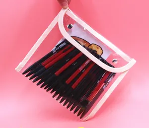 Detail view of transparent PVC pencil case with button closure and pens inside