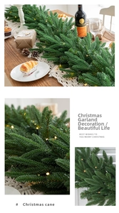 Detail of green PE Christmas garland with warm LED lights for festive table decoration